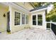 Back porch with white railing, white painted floor, and yellow siding at 6201 King Croydon Ct Ct, Raleigh, NC 27603