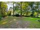 Expansive backyard with lush greenery and mature trees surrounds this beautiful home at 6201 King Croydon Ct Ct, Raleigh, NC 27603