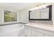 Bright bathroom features a soaking tub, quartz countertops, and mosaic backsplash at 6201 King Croydon Ct Ct, Raleigh, NC 27603
