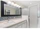 Bathroom featuring quartz countertops, mosaic backsplash, and a walk-in shower at 6201 King Croydon Ct Ct, Raleigh, NC 27603