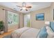 Cozy bedroom with ceiling fan, blue accent pillows and view of outdoor scenery at 6201 King Croydon Ct Ct, Raleigh, NC 27603