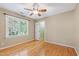 Neutral bedroom with hardwood floors, ceiling fan, and view through doorway at 6201 King Croydon Ct Ct, Raleigh, NC 27603