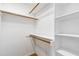 Walk-in closet with built-in shelving and hardwood floors at 6201 King Croydon Ct Ct, Raleigh, NC 27603