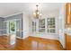 Elegant dining room with hardwood floors, chandelier, and access to outdoor views at 6201 King Croydon Ct Ct, Raleigh, NC 27603