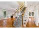 Bright foyer showcasing staircase, hardwood floors, fireplace, and views into other living spaces at 6201 King Croydon Ct Ct, Raleigh, NC 27603