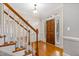 Open foyer with hardwood floors, staircase, and view of the front door and natural light at 6201 King Croydon Ct Ct, Raleigh, NC 27603