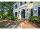Inviting front entrance with brick steps, black front door with sidelights, and well-manicured landscaping at 6201 King Croydon Ct Ct, Raleigh, NC 27603