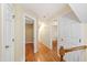 Upstairs hallway featuring hardwood floors and white doors at 6201 King Croydon Ct Ct, Raleigh, NC 27603