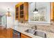 Close-up of kitchen with granite countertops, stainless steel sink, and ample natural light at 6201 King Croydon Ct Ct, Raleigh, NC 27603