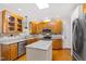 Modern kitchen featuring wooden cabinets, granite countertops, stainless steel appliances, and center island at 6201 King Croydon Ct Ct, Raleigh, NC 27603