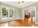 Living room with hardwood floors, large windows, and a view into another room at 6201 King Croydon Ct Ct, Raleigh, NC 27603