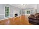 Cozy living room featuring hardwood floors, a fireplace, and french doors at 6201 King Croydon Ct Ct, Raleigh, NC 27603