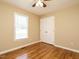 Bedroom with a window, laminate flooring, and double door closet at 635 Raymond Dr, Wendell, NC 27591