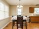 Bright dining room with a floral tablecloth, chandelier, and hardwood floors at 635 Raymond Dr, Wendell, NC 27591