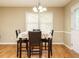 Bright dining room with a floral tablecloth, chandelier, hardwood floors, and a window at 635 Raymond Dr, Wendell, NC 27591