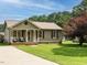 Charming single-story home with a well-maintained lawn, and a covered front porch at 635 Raymond Dr, Wendell, NC 27591