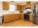 Traditional kitchen featuring stainless steel appliances and oak cabinets with laminate countertops at 635 Raymond Dr, Wendell, NC 27591