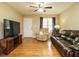 Comfortable living room featuring hardwood floors, a ceiling fan, and cozy seating at 635 Raymond Dr, Wendell, NC 27591