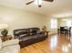 Spacious living room with hardwood floors, a leather sofa, and dining area access at 635 Raymond Dr, Wendell, NC 27591