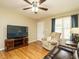 Cozy living room with hardwood floors, a ceiling fan, and a comfortable recliner at 635 Raymond Dr, Wendell, NC 27591