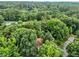 Distant aerial view of homes nestled within a forest of green trees at 6422 English Oaks Dr, Raleigh, NC 27615