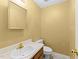 Cozy half-bathroom featuring a golden faucet, an oval sink, and a standard toilet at 6422 English Oaks Dr, Raleigh, NC 27615