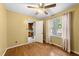 Cozy bedroom with wood flooring, ceiling fan, and kitchen view at 6422 English Oaks Dr, Raleigh, NC 27615
