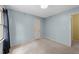 Simple bedroom featuring light blue walls, neutral carpet, and natural light at 6422 English Oaks Dr, Raleigh, NC 27615
