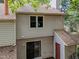Exterior side view of home with beige siding and red door at 6422 English Oaks Dr, Raleigh, NC 27615