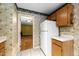 Kitchen with oak cabinets, white appliances, and an open view into the living area at 6422 English Oaks Dr, Raleigh, NC 27615