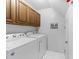 Functional laundry room with a washer, dryer, and ample overhead cabinet storage at 6422 English Oaks Dr, Raleigh, NC 27615