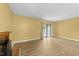 Bright living room with wood floors, fireplace, and sliding glass doors at 6422 English Oaks Dr, Raleigh, NC 27615