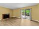 Bright living room with fireplace and access to the backyard through sliding glass doors at 6422 English Oaks Dr, Raleigh, NC 27615