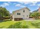 Back exterior view of the home and backyard showing the lawn, patio, trees and siding at 6608 Quiet Cove Ct, Raleigh, NC 27612