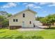 A back exterior view of the home and backyard shows the patio, lawn and home design at 6608 Quiet Cove Ct, Raleigh, NC 27612