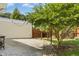This backyard features a beautiful stone patio, a lush green lawn, and mature trees for privacy at 6608 Quiet Cove Ct, Raleigh, NC 27612