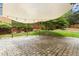 Backyard patio with canopy features stone tile flooring, a fenced perimeter and a tree line at 6608 Quiet Cove Ct, Raleigh, NC 27612