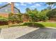 Landscaped backyard features a stone patio, a wood trellis, and a lush green lawn, perfect for relaxing outdoors at 6608 Quiet Cove Ct, Raleigh, NC 27612
