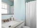 Bright bathroom featuring a vanity with granite countertop and walk-in shower with a white shower curtain at 6608 Quiet Cove Ct, Raleigh, NC 27612