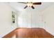 Bedroom with hardwood flooring, a ceiling fan, and two closets at 6608 Quiet Cove Ct, Raleigh, NC 27612