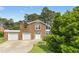 Charming brick home featuring an attached two car garage, landscaped front yard, and brick chimney at 6608 Quiet Cove Ct, Raleigh, NC 27612
