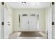 Bright foyer featuring a double front door, decorative sidelights, tile flooring, and ample natural light at 6608 Quiet Cove Ct, Raleigh, NC 27612