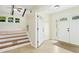 Inviting foyer with a decorative front door, tile flooring, and stairs leading to the upper level at 6608 Quiet Cove Ct, Raleigh, NC 27612