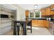 Cozy kitchen with light wood cabinetry, tile floors, stainless appliances, and a spacious walk-in pantry at 6608 Quiet Cove Ct, Raleigh, NC 27612