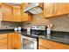 Features stainless steel appliances, granite countertops, and honey-colored wood cabinetry at 6608 Quiet Cove Ct, Raleigh, NC 27612