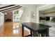 Open floor plan featuring hardwood floors, exposed beams, a brick fireplace, and natural light at 6608 Quiet Cove Ct, Raleigh, NC 27612