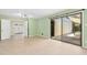 Living room with neutral walls, tile-look flooring, and sliding glass door to a patio at 6608 Quiet Cove Ct, Raleigh, NC 27612