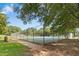 Community tennis court in park with blue and green surface in a fenced enclosure at 6608 Quiet Cove Ct, Raleigh, NC 27612