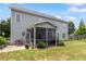 Exterior view of home showing a screened patio, deck, and large yard at 6901 Rex Rd, Holly Springs, NC 27540