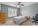 Comfortable bedroom featuring a ceiling fan and a large window at 6901 Rex Rd, Holly Springs, NC 27540